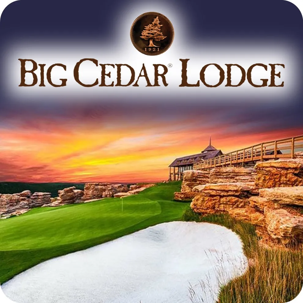 Top section: A dark navy blue banner that fades into a white glow behind the text. It features the official Big Cedar Lodge logo, including a circular bronze emblem with a cedar tree and the year "1921," followed by the name in a rustic, brown serif font. Bottom section: A stunning landscape photograph of a golf course at sunset. The image showcases a bright white sand bunker in the foreground, followed by a lush green fairway that winds along rugged, tiered rock formations. In the background, a wooden lodge building with a balcony overlooks the course under a vibrant orange and purple sky.